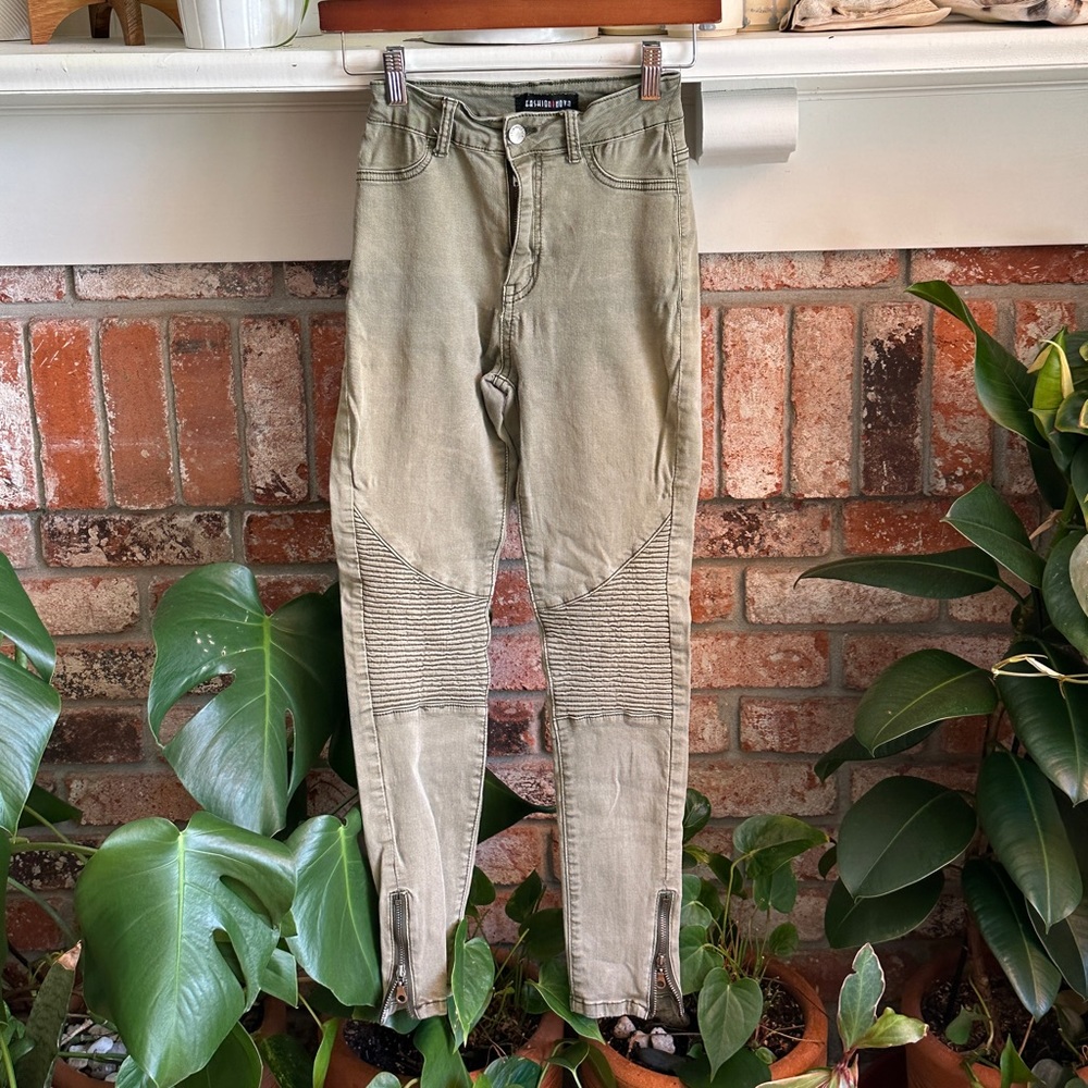 Light green high waisted moto pants.